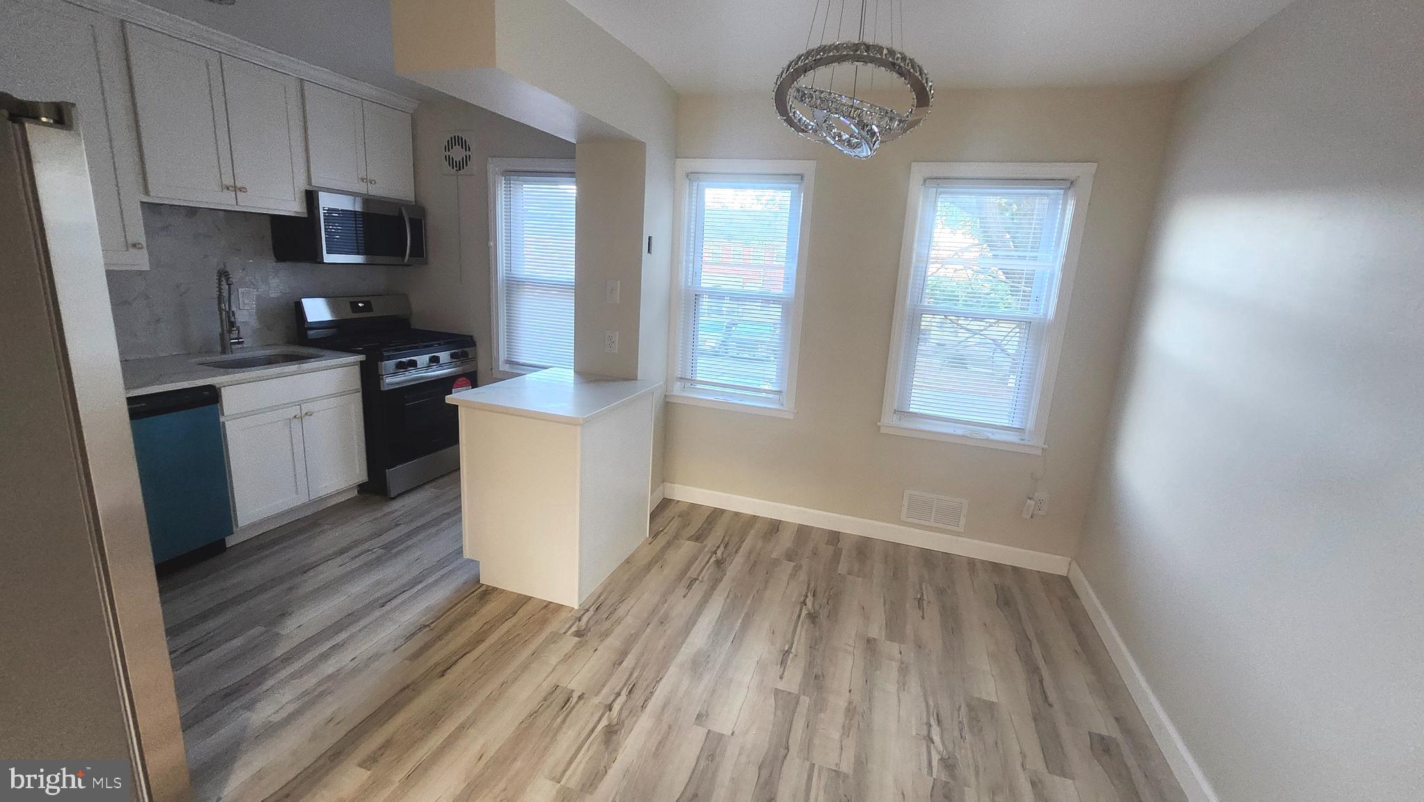 1001 Cameron Road Baltimore, MD 21212 - Photo 12 of 46 a kitchen with a sink and wooden floor