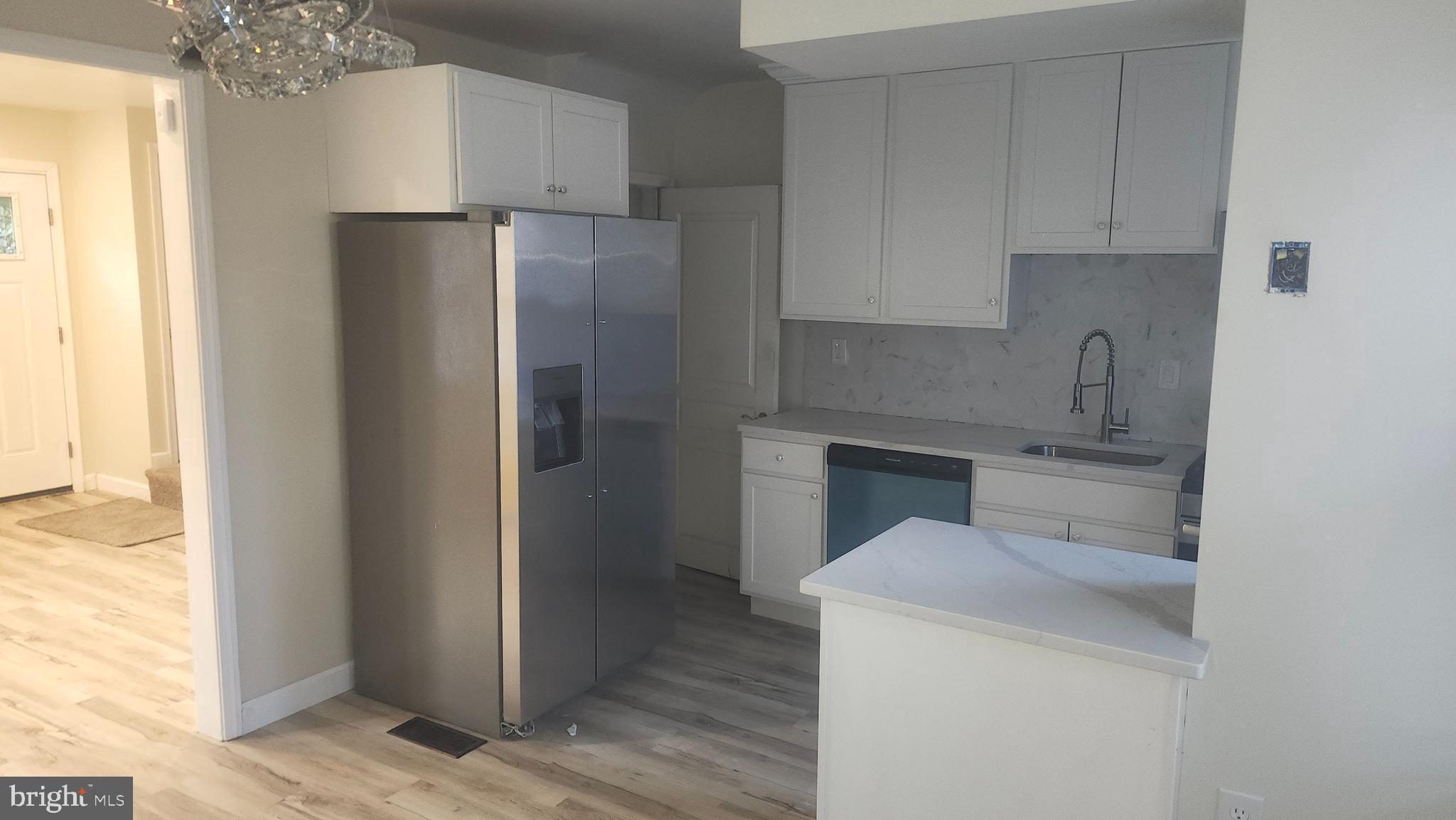 1001 Cameron Road Baltimore, MD 21212 - Photo 16 of 46 a kitchen with a refrigerator sink and cabinets