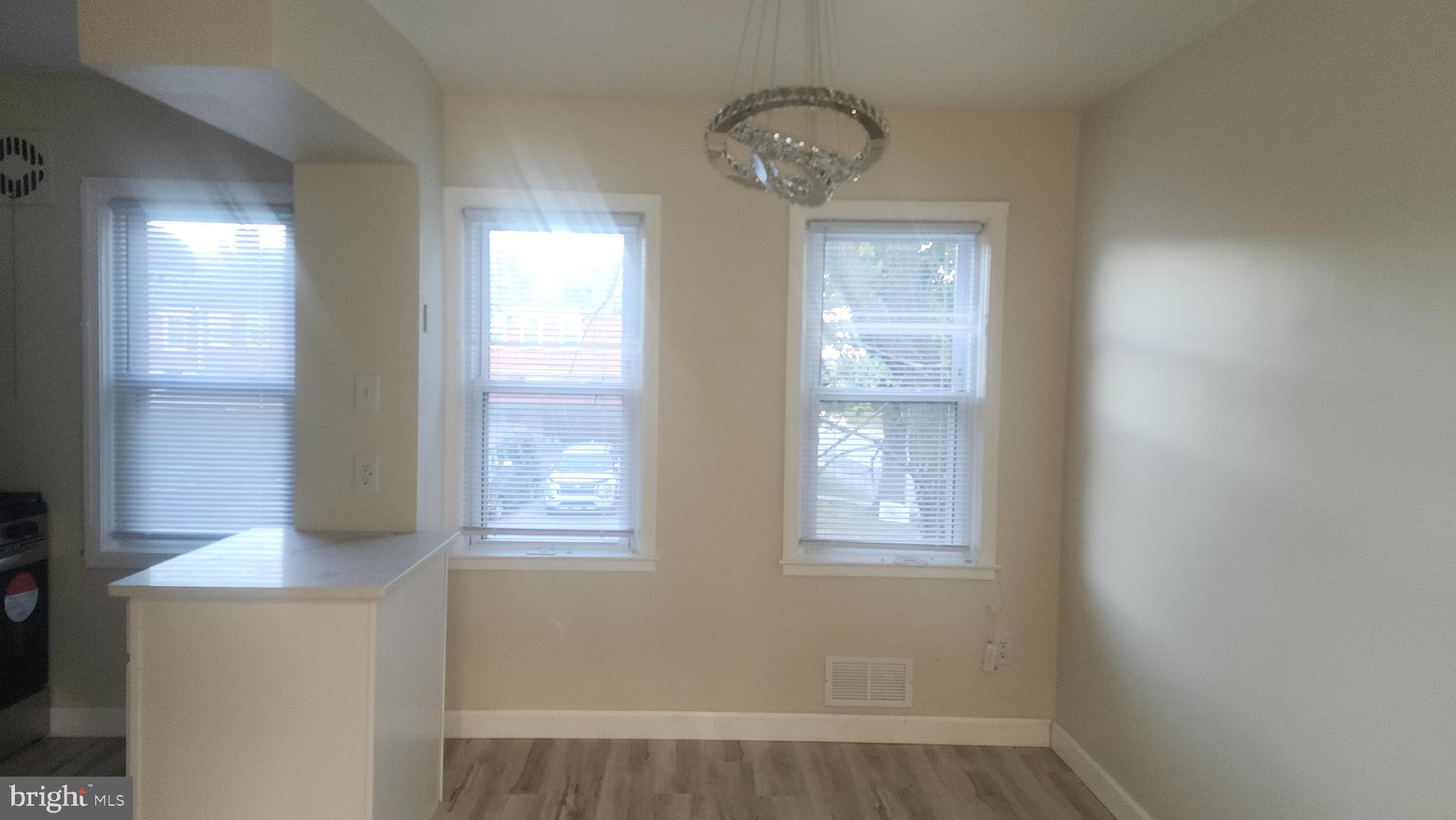 1001 Cameron Road Baltimore, MD 21212 - Photo 17 of 46 a view of an empty room with wooden floor and a window