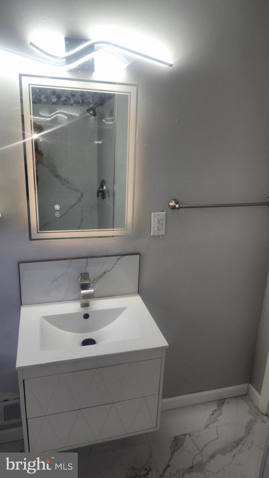 1001 Cameron Road Baltimore, MD 21212 - Photo 22 of 46 a bathroom with a sink and mirror