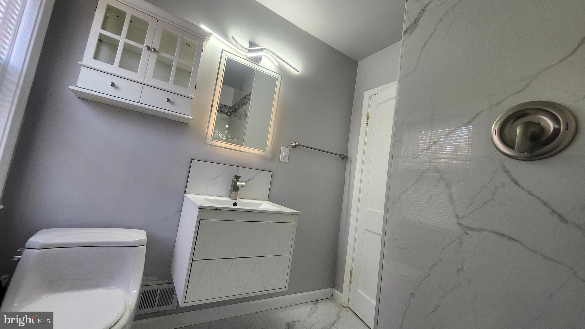 1001 Cameron Road Baltimore, MD 21212 - Photo 23 of 46 a bathroom with a sink a toilet and vanity