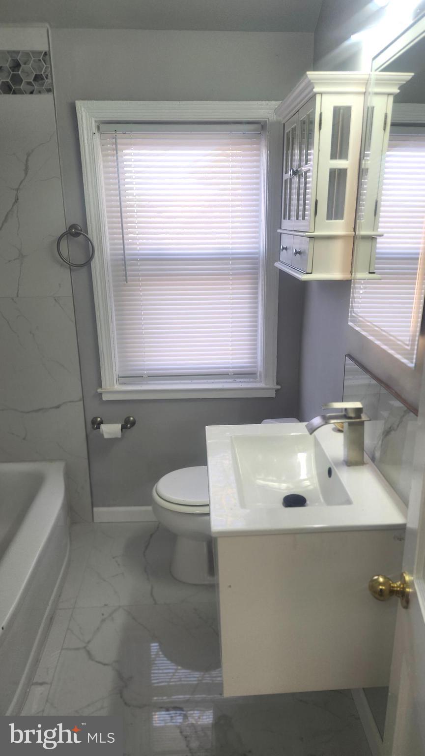 1001 Cameron Road Baltimore, MD 21212 - Photo 26 of 46 a bathroom with a sink a toilet and bathtub