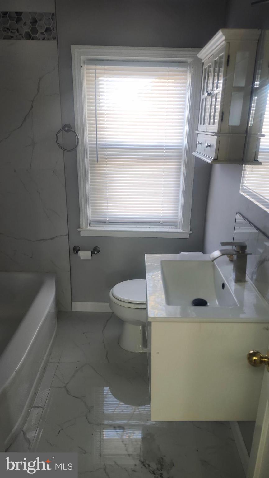 1001 Cameron Road Baltimore, MD 21212 - Photo 27 of 46 a bathroom with a sink a toilet and bathtub