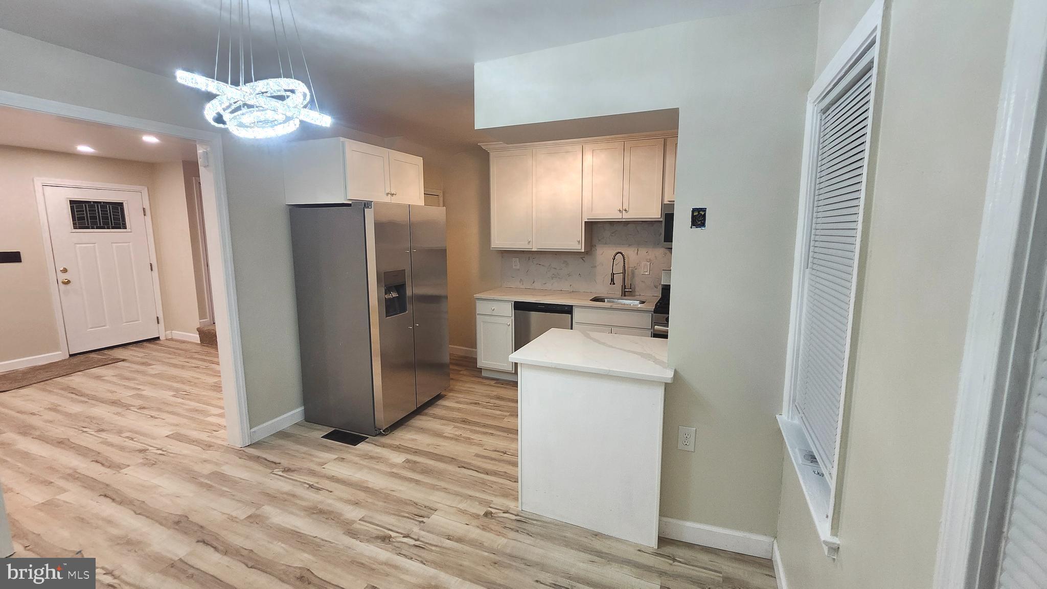 1001 Cameron Road Baltimore, MD 21212 - Photo 4 of 46 a room with kitchen island a sink stainless steel appliances and cabinets