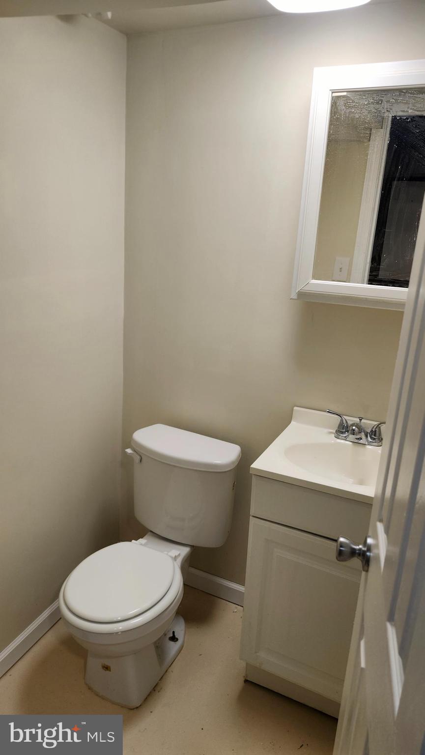 1001 Cameron Road Baltimore, MD 21212 - Photo 42 of 46 a white toilet sitting next to a white sink and vanity