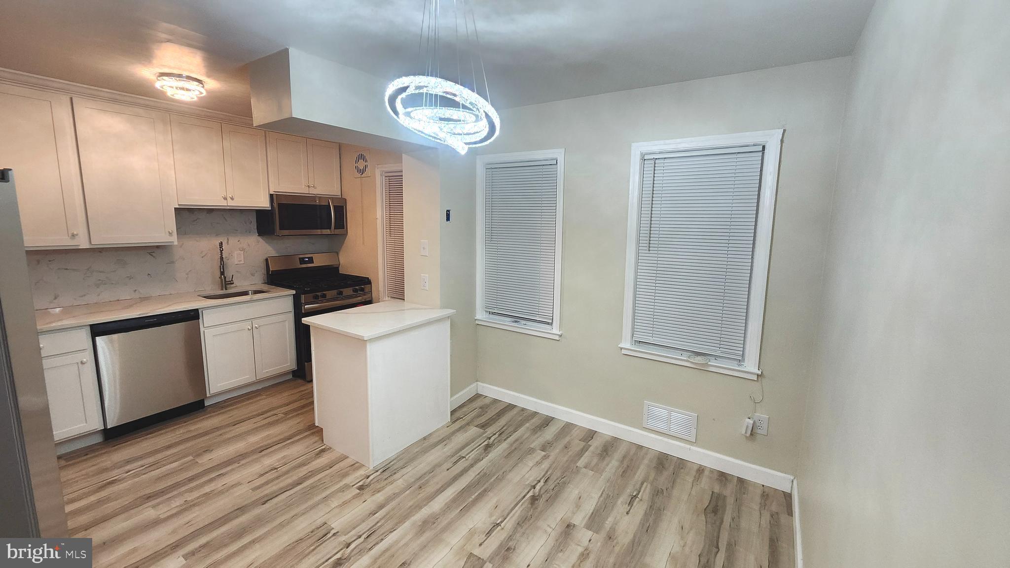 1001 Cameron Road Baltimore, MD 21212 - Photo 5 of 46 a kitchen with a sink cabinets stainless steel appliances and a window