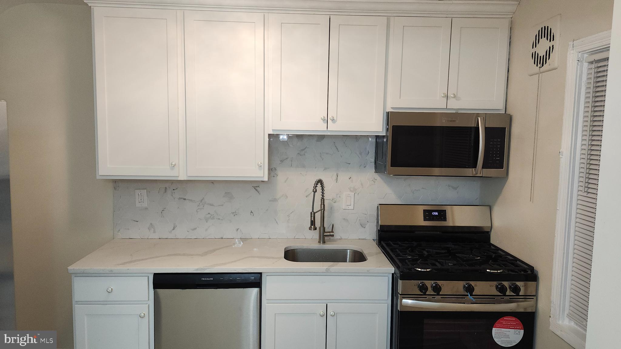 1001 Cameron Road Baltimore, MD 21212 - Photo 8 of 46 a kitchen with stainless steel appliances granite countertop a sink stove and microwave