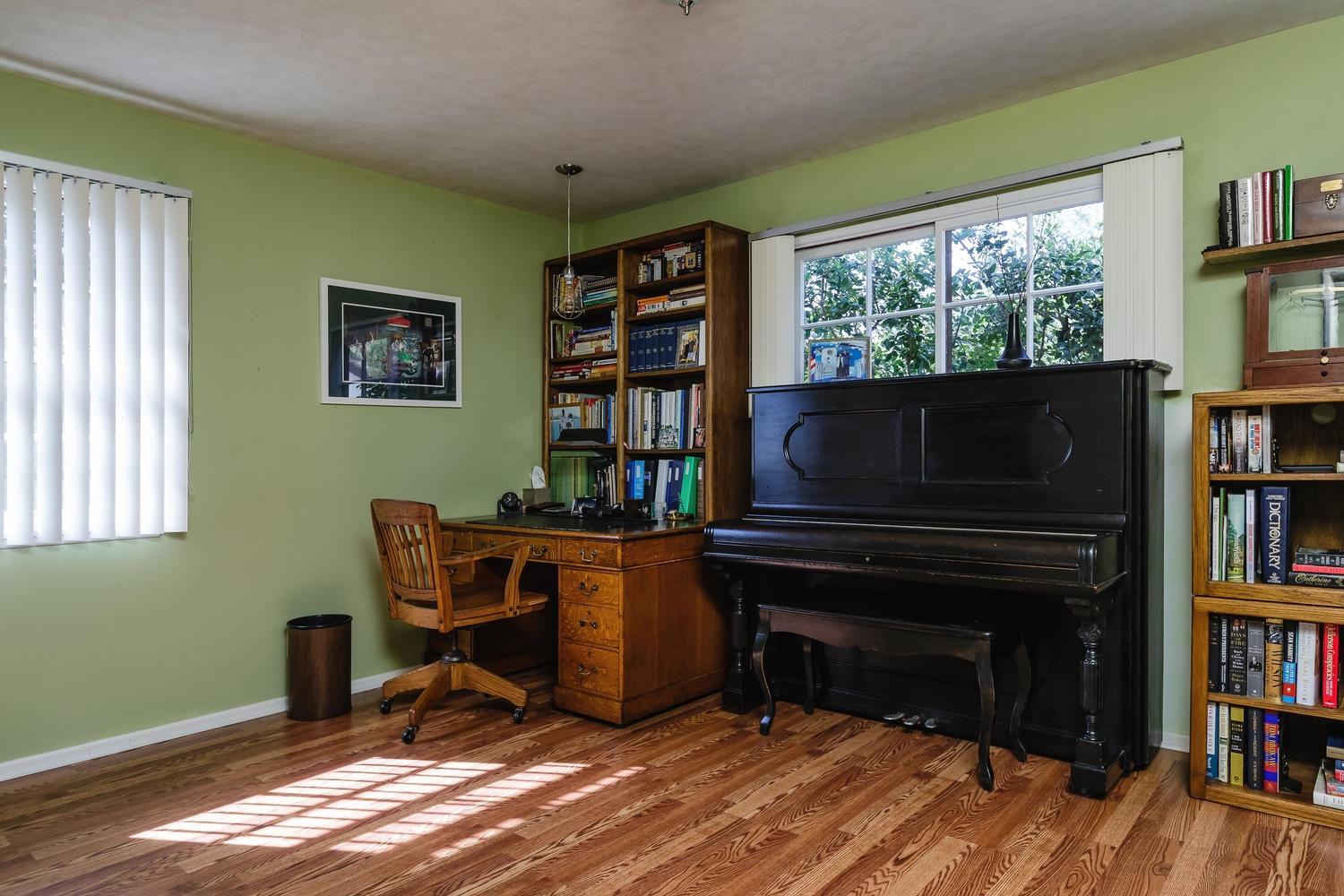 819 Daly Road Ojai, CA 93023 - Photo 15 of 25 a view of a workspace with furniture and a book shelf