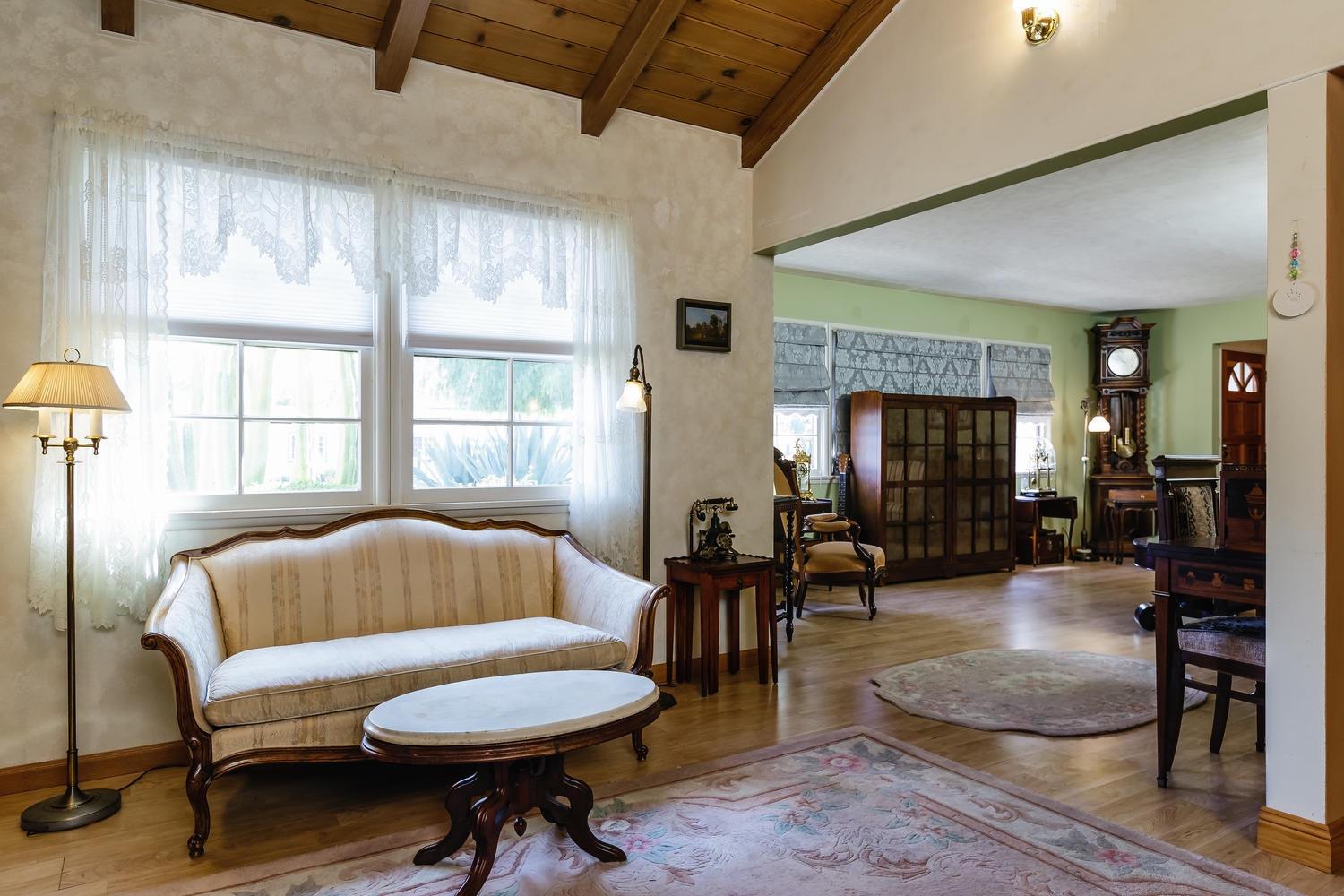 819 Daly Road Ojai, CA 93023 - Photo 6 of 25 a living room with furniture a fireplace and a large window