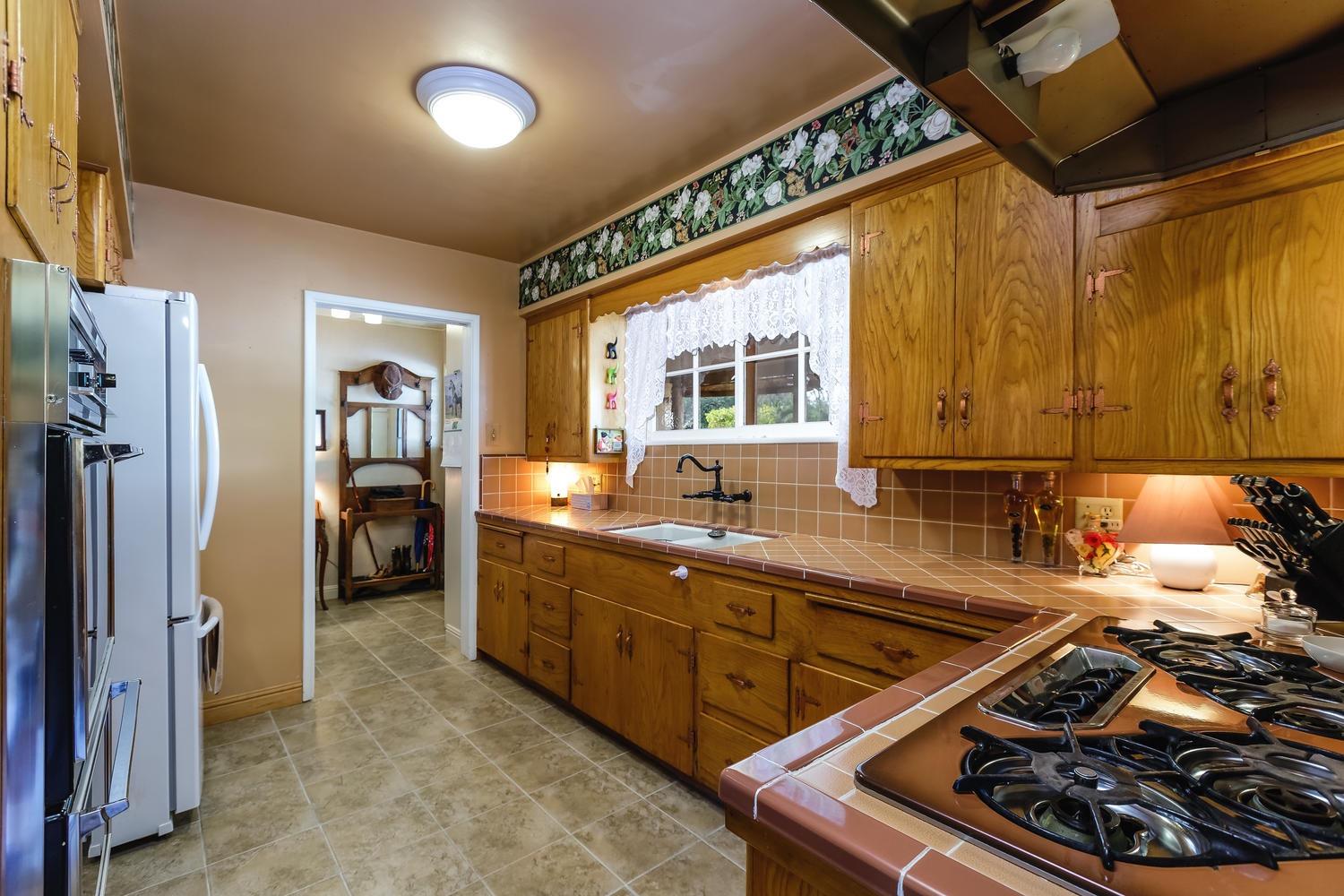 819 Daly Road Ojai, CA 93023 - Photo 9 of 25 a kitchen with a sink stove and refrigerator
