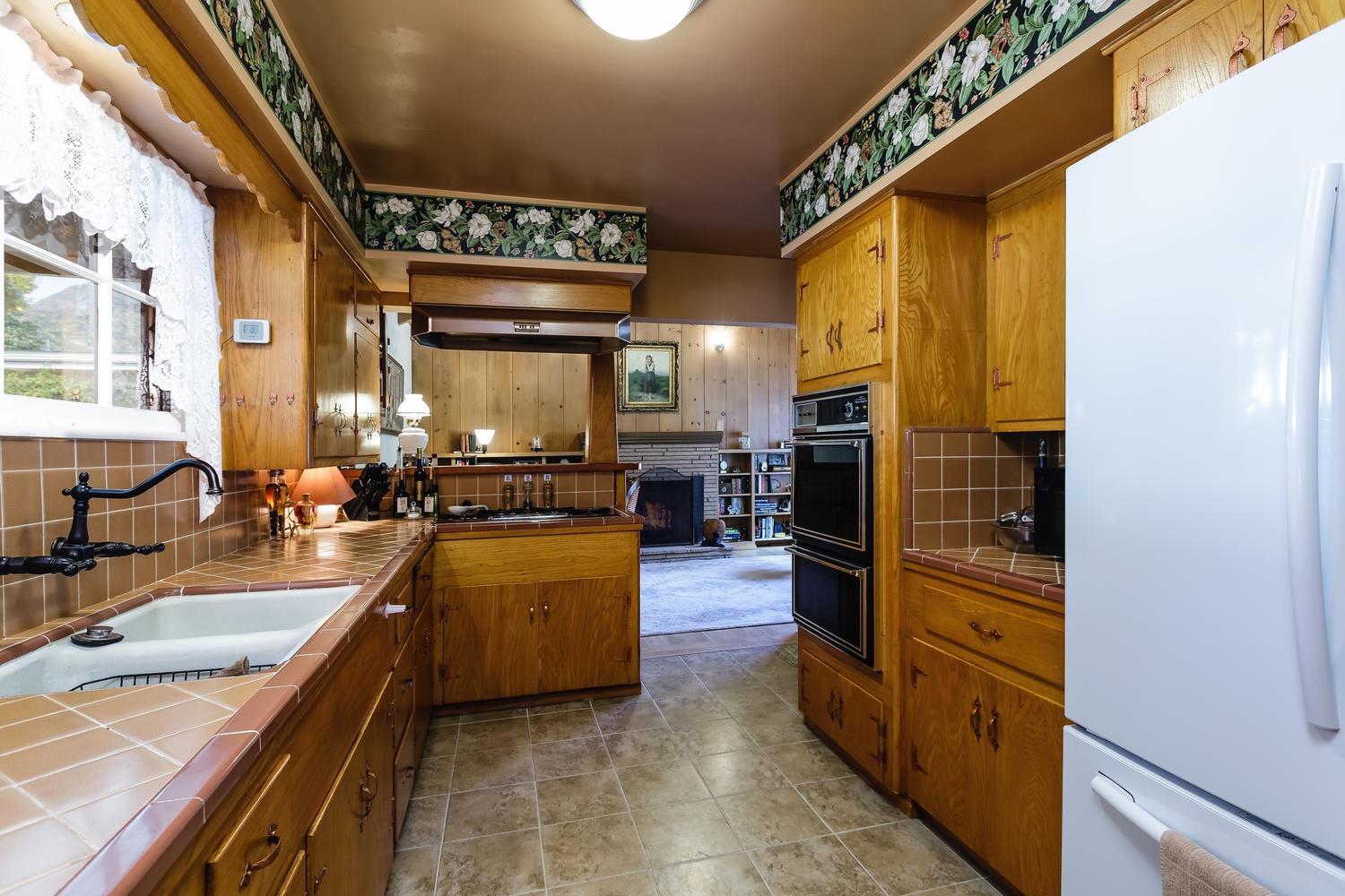 819 Daly Road Ojai, CA 93023 - Photo 10 of 25 a kitchen with stainless steel appliances granite countertop a sink and a refrigerator