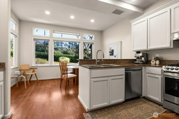 a kitchen with a table chairs stove and cabinets