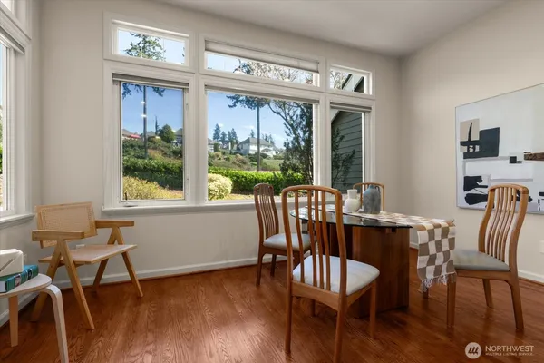 a view of a dining room with furniture window and wooden floor