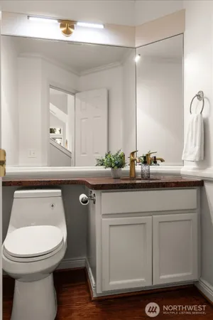 a bathroom with a toilet a sink and a mirror
