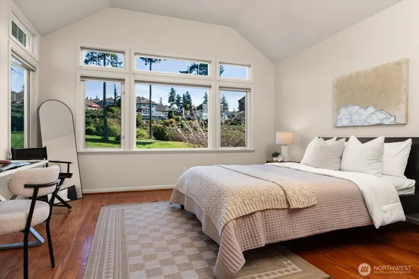 a bedroom with a bed and a large window