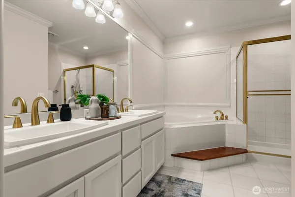 a bathroom with a tub sink and mirror