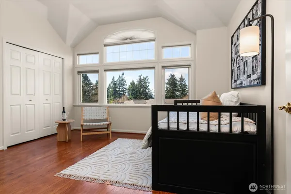 a view of a bedroom with furniture window and wooden floor