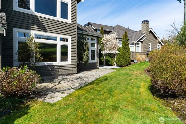 a front view of a house with a garden and garage