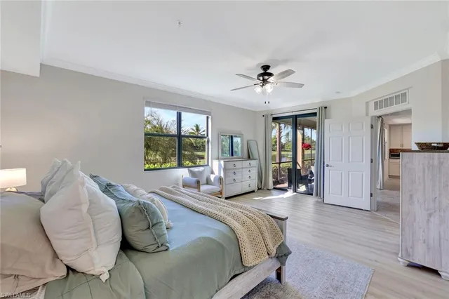 a bedroom with furniture and a chandelier