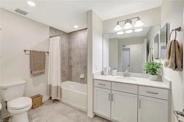 a living room with furniture and a baby crib