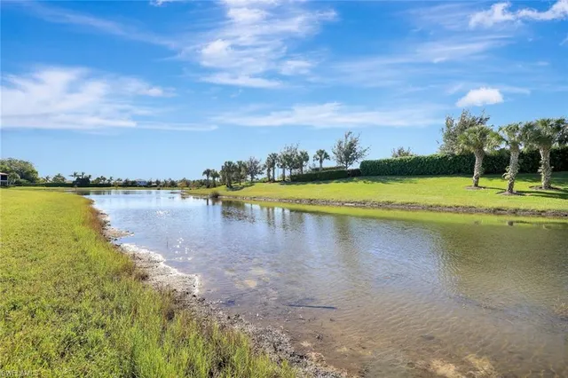 a view of a lake with houses in the background