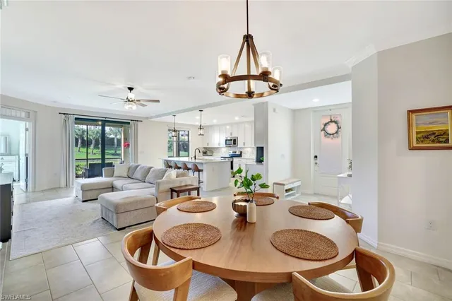 a living room with dining table and chairs