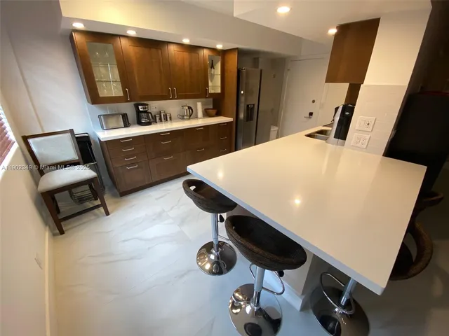 a kitchen with a sink appliances and cabinets