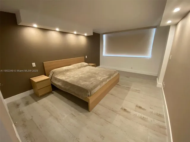a bedroom with a bed and a chair