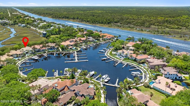 a living room with couches and a dining table with kitchen view
