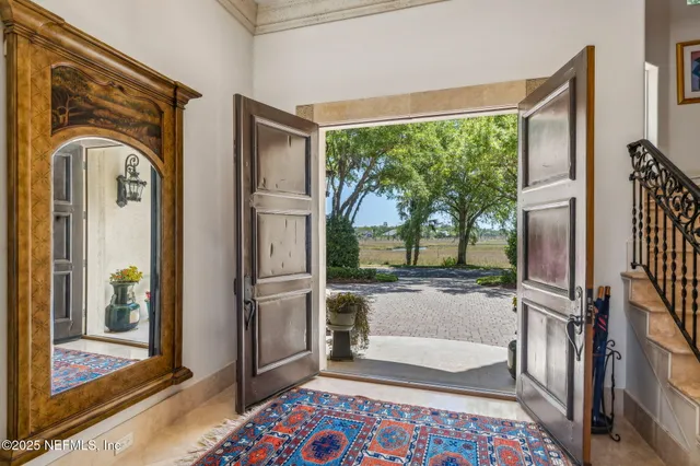a view of a white building with swimming pool in front of it