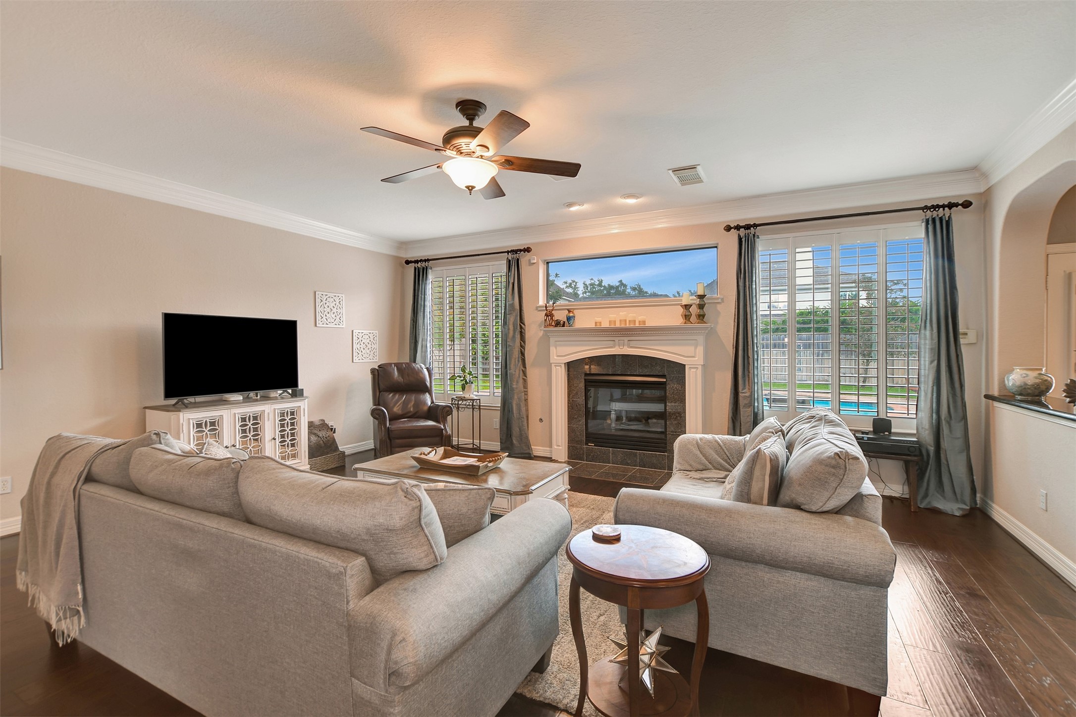 15918 Lake Loop Drive Cypress, TX 77433 - Photo 14 of 50 a living room with furniture a fireplace and a flat screen tv