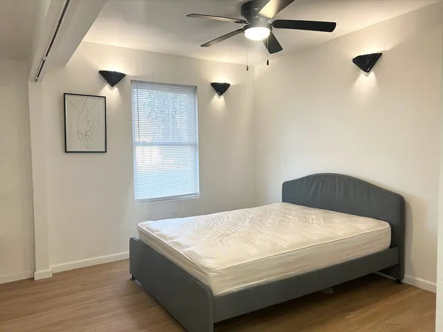 a bedroom with a bed and a window