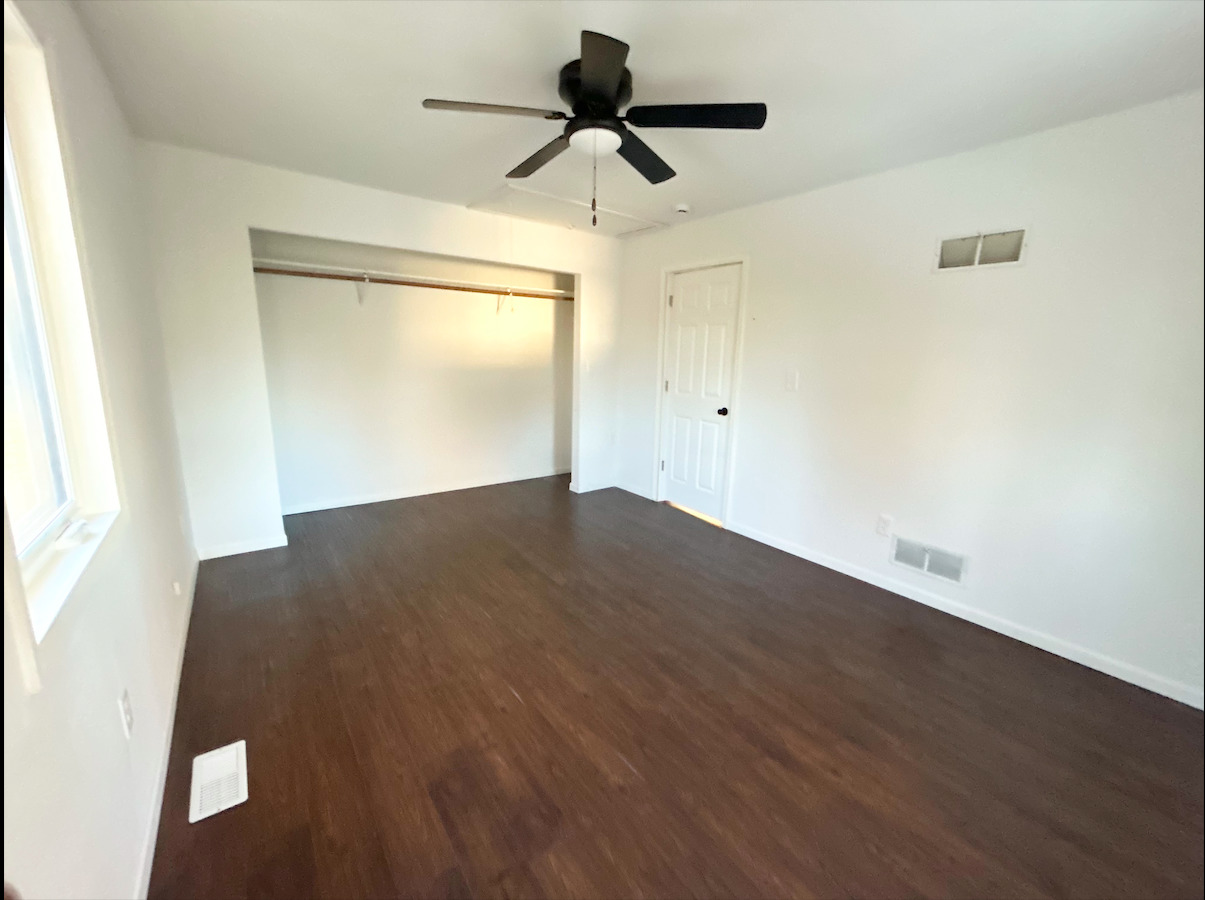 2351 Caton Farm Road Crest Hill, IL 60403 - Photo 18 of 24 a view of a room with wooden floor and a ceiling fan