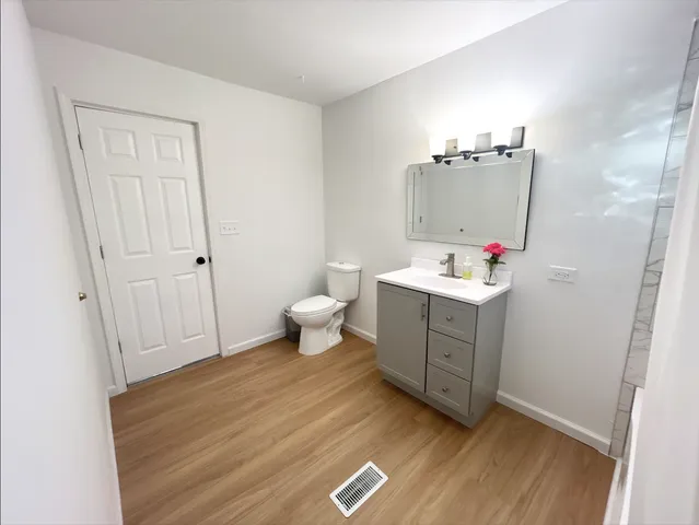 a room with a window and dresser