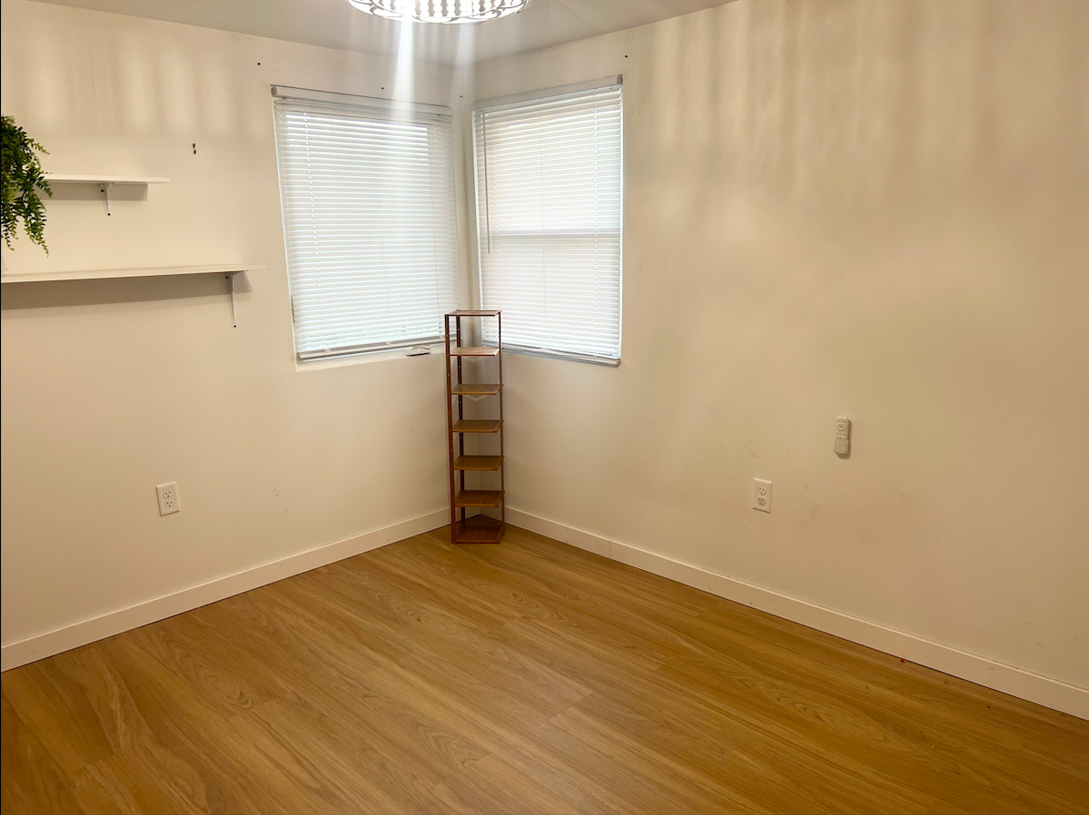2351 Caton Farm Road Crest Hill, IL 60403 - Photo 5 of 24 a view of an empty room with wooden floor and a window