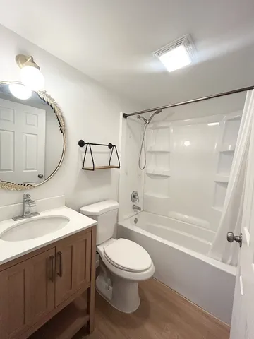 a bathroom with a toilet a sink and a mirror