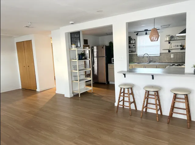 a view of kitchen with cabinets and wooden floor