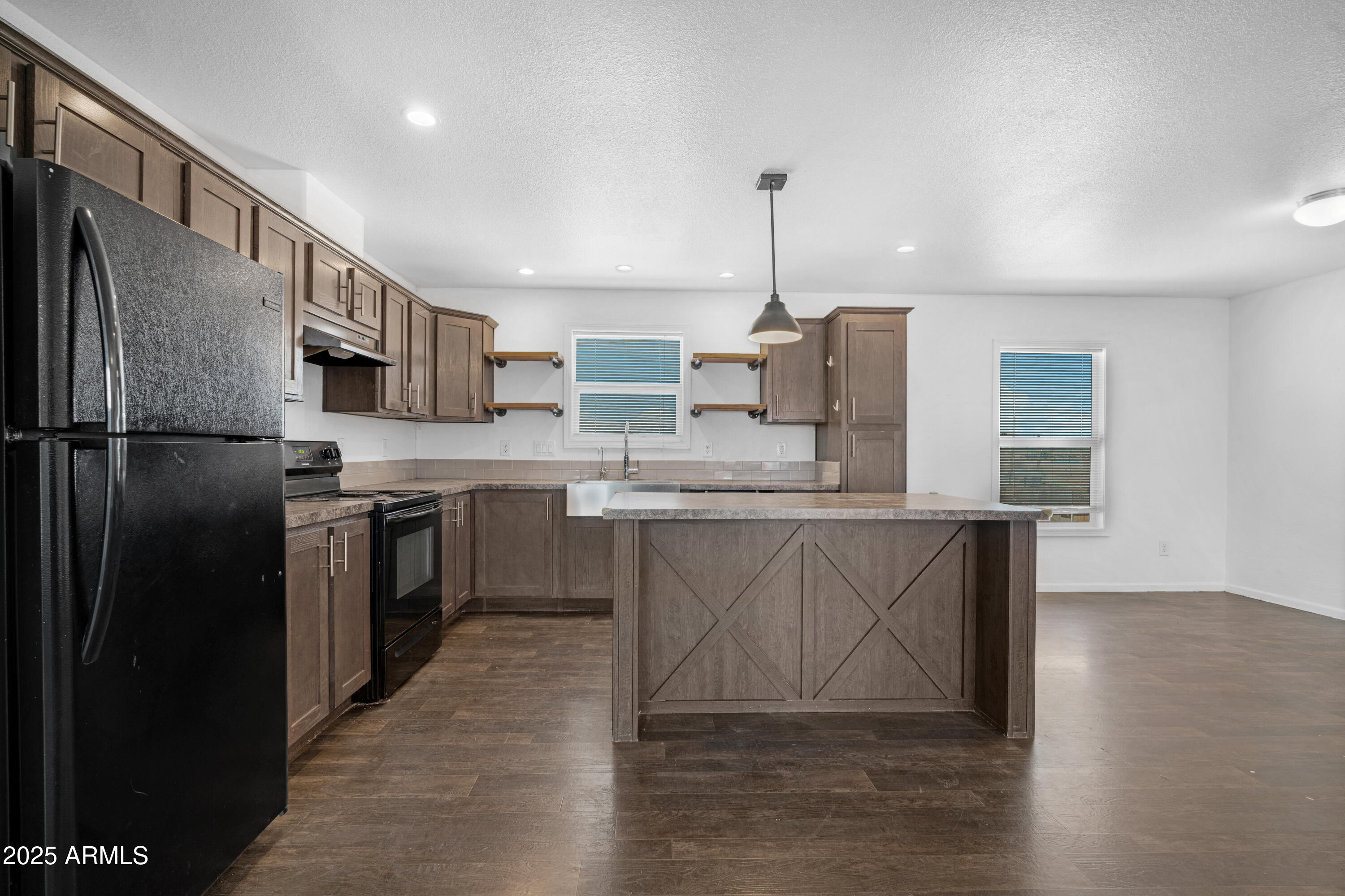 4318 North White Road Maricopa, AZ 85139 - Photo 3 of 21 a kitchen with stainless steel appliances granite countertop a refrigerator a sink dishwasher a stove and a microwave oven on granite countertops