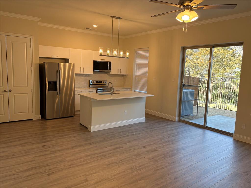 6357 Manson Court Dallas, TX 75227 - Photo 2 of 7 a view of kitchen with stainless steel appliances granite countertop cabinets and wooden floor
