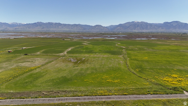 320 South 5400 West Logan, UT 84321 - Photo 19 of 42 Expansive green fields featuring natural water features and distant snow-capped mountains