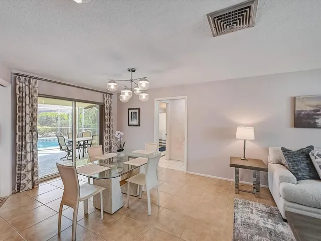 a view of a dining room with furniture a chandelier and a large mirror