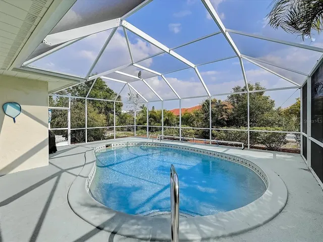 a living room with furniture a chandelier and a flat screen tv