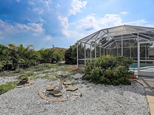 a kitchen with kitchen island granite countertop a sink a counter space appliances and cabinets