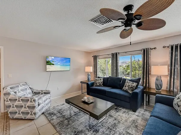 a bathroom with a granite countertop sink a mirror and shower