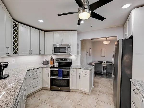a bedroom with a large bed and a ceiling fan