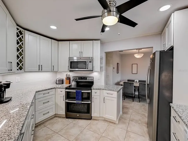 a bedroom with a large bed and a ceiling fan