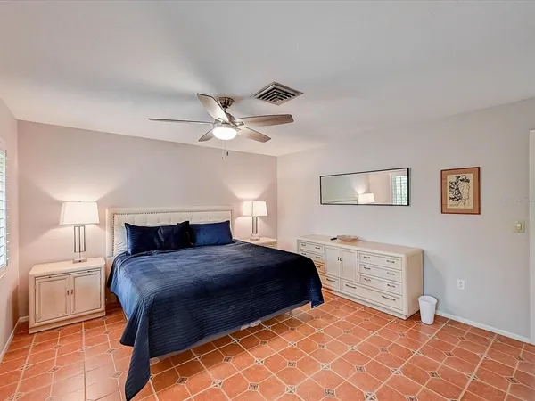 a big white house with a big yard and large trees