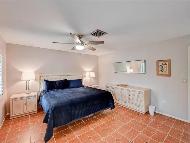 a big white house with a big yard and large trees