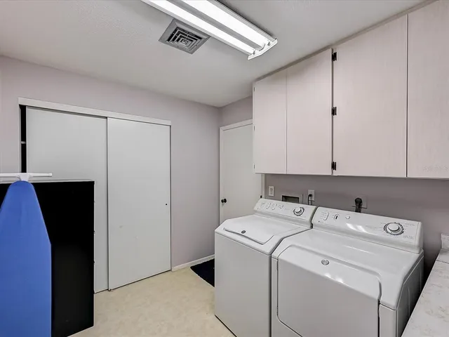 a view of a patio with table and chairs and potted plants
