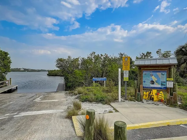 a front view of a building with a garden and plants